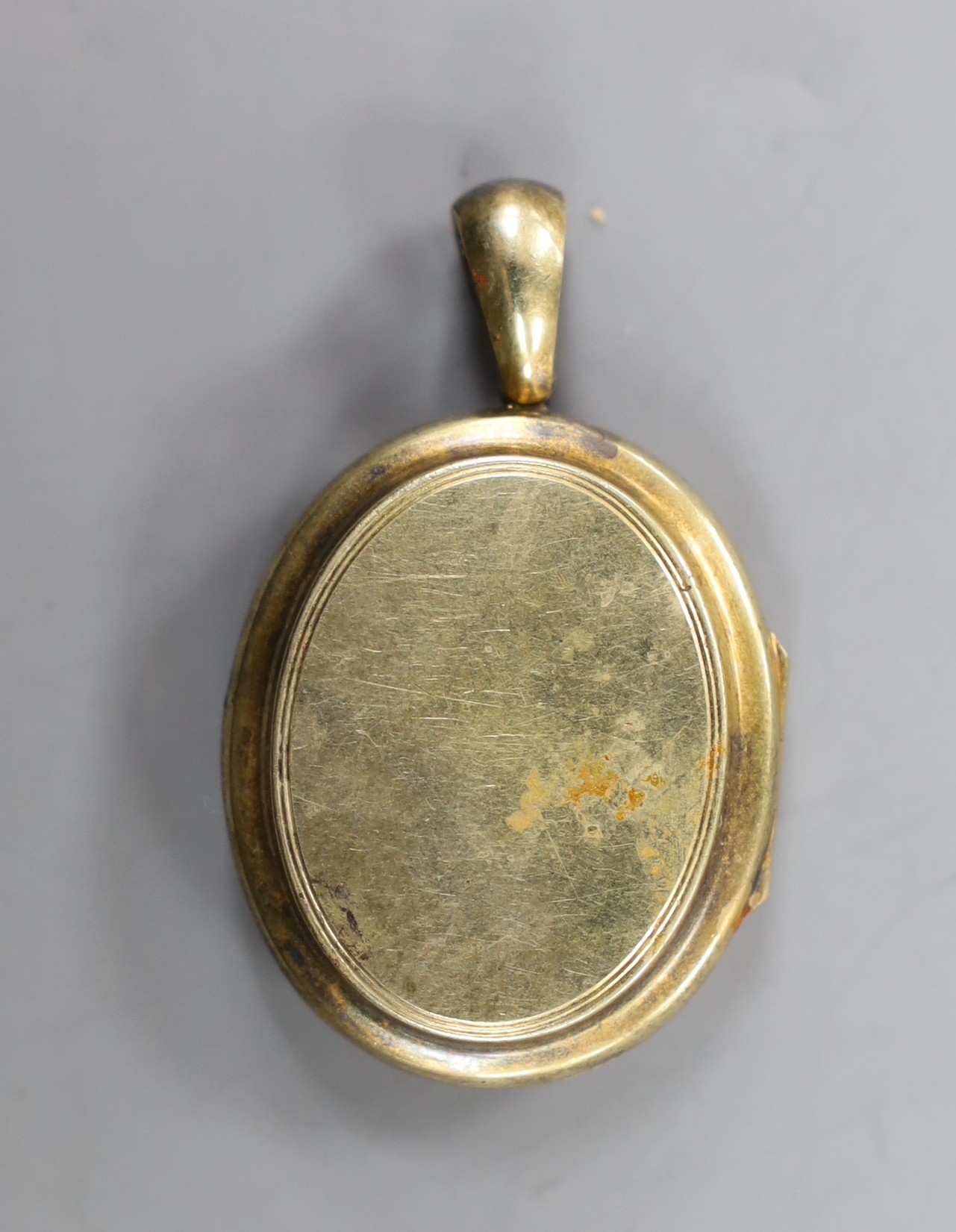 A late Victorian yellow metal, turquoise and seed pearl set oval locket, overall 48mm, gross weight 16.2 grams.